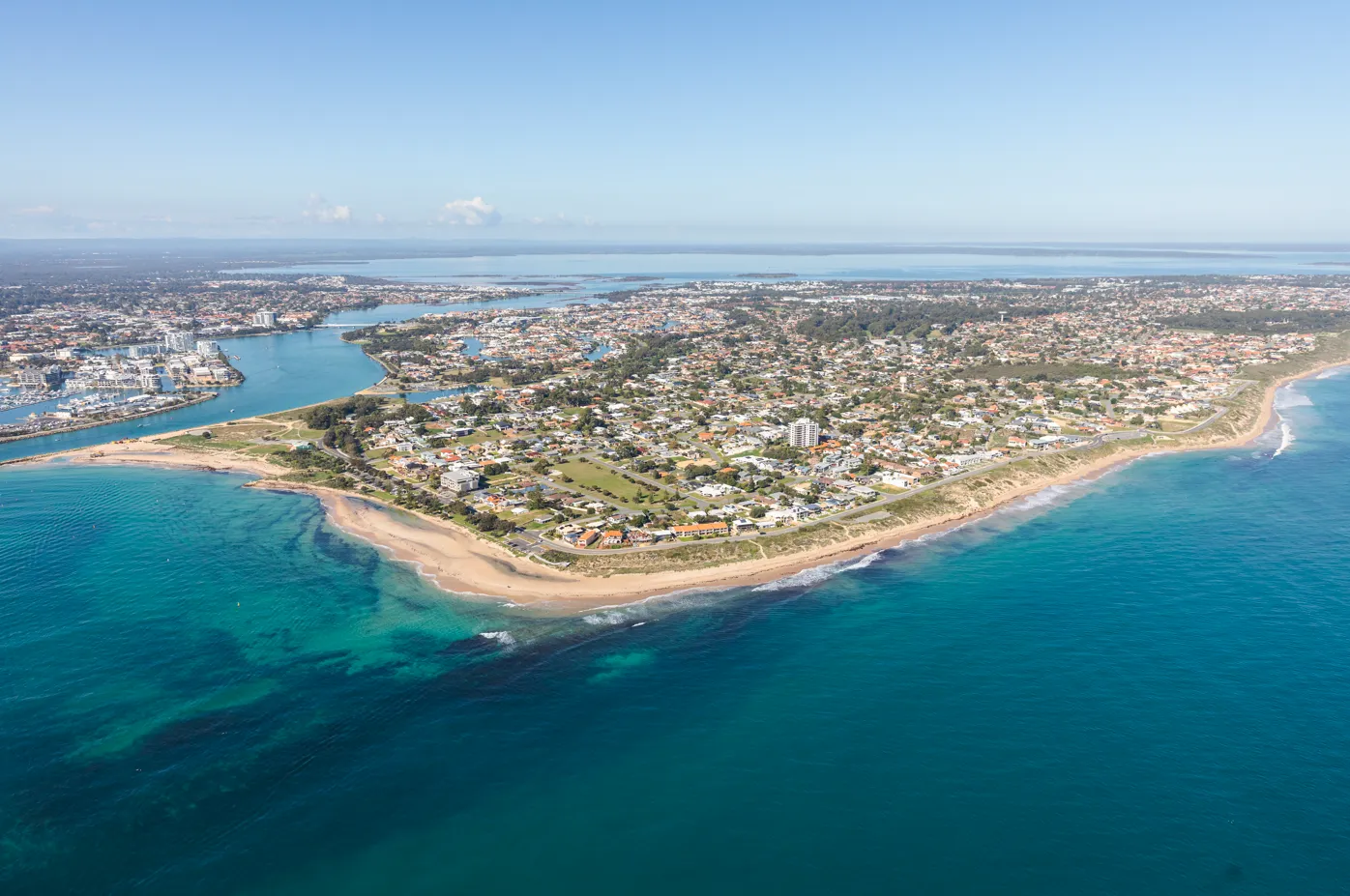 Aerial view of Doddi’s Beach, showing the coastline, ocean and Mandurah waterways.